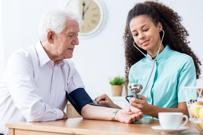 an-older-man-is-having-his-blood-pressure-measured-by-a-woman